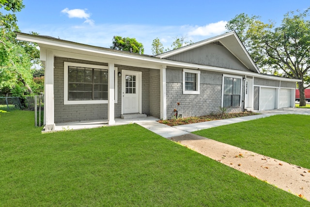 single story home featuring a garage and a front lawn