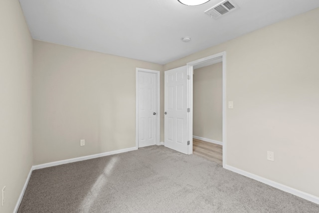 unfurnished room with light colored carpet