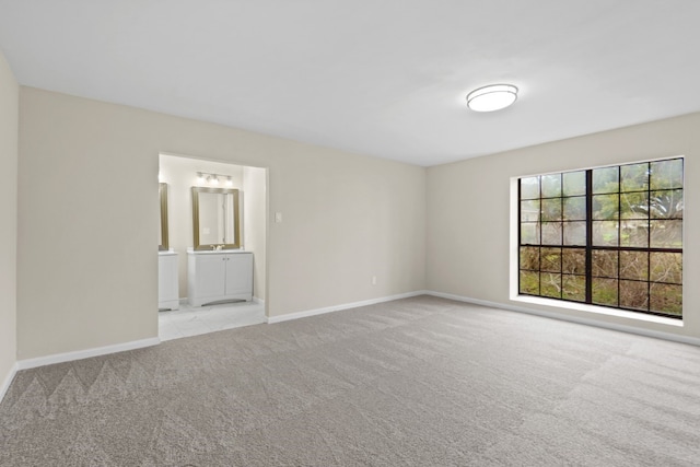 unfurnished room featuring light colored carpet