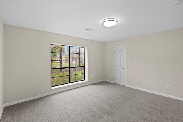 unfurnished room featuring carpet