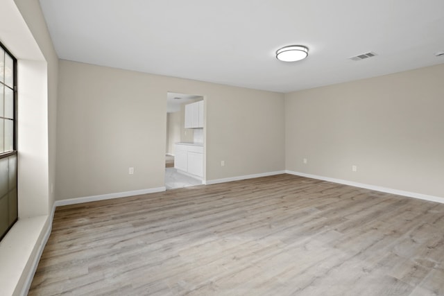 unfurnished room with light hardwood / wood-style flooring