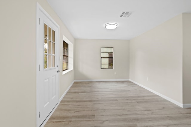 unfurnished room with light hardwood / wood-style flooring