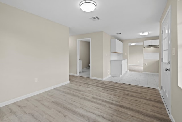 unfurnished room with light wood-type flooring