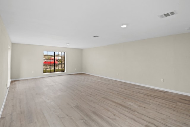 empty room with light hardwood / wood-style flooring