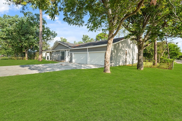 ranch-style house with a garage and a front lawn