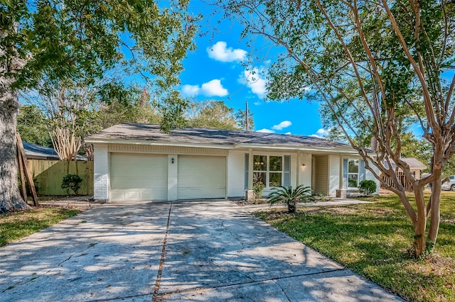 ranch-style house featuring a front lawn and a garage