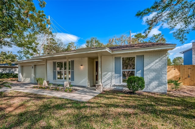 ranch-style home with a front lawn and a garage