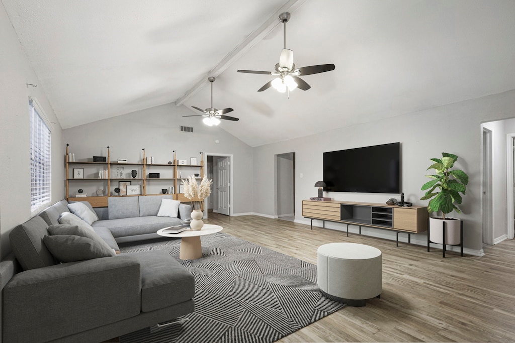 living room with hardwood / wood-style flooring, vaulted ceiling with beams, and ceiling fan