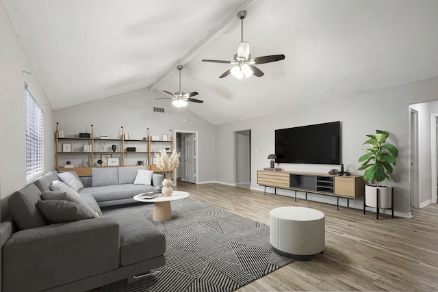 living room with hardwood / wood-style flooring, vaulted ceiling with beams, and ceiling fan