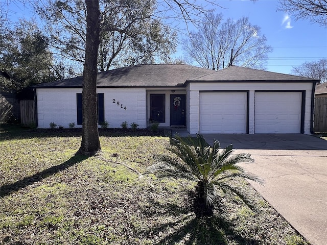 ranch-style house with a garage and a front lawn