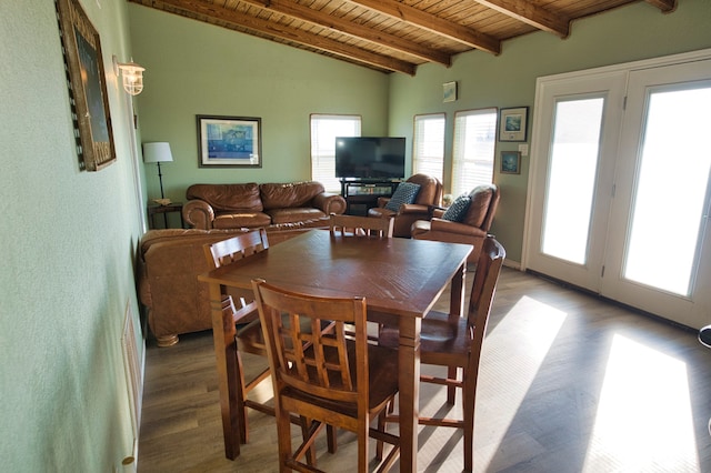 dining room with wood ceiling, hardwood / wood-style flooring, and lofted ceiling with beams