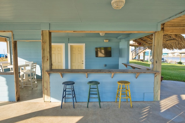 view of patio featuring an outdoor bar