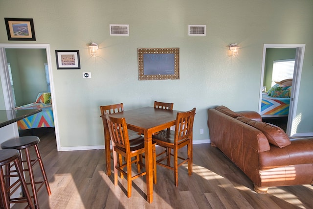 dining area with dark wood-type flooring