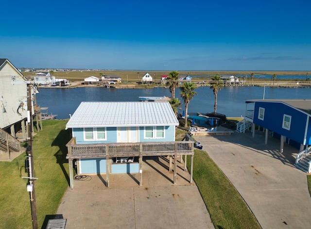 view of dock featuring a yard and a water view