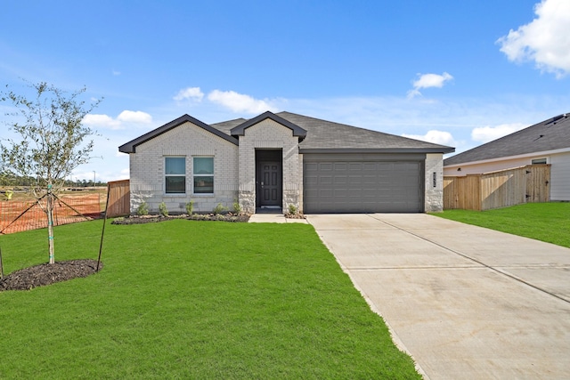 view of front of property featuring a garage and a front lawn