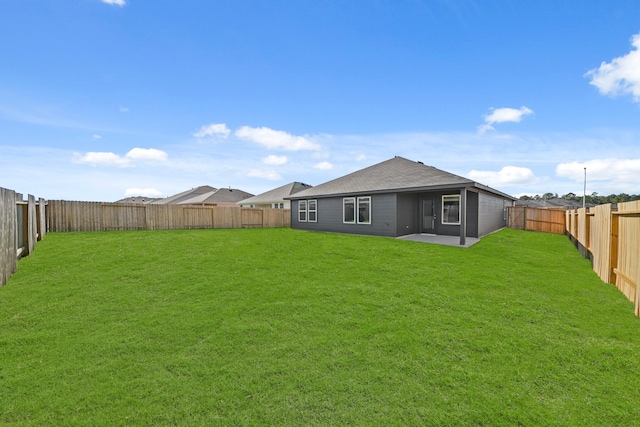 back of house with a patio and a lawn