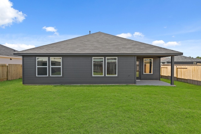 back of property with a patio and a lawn