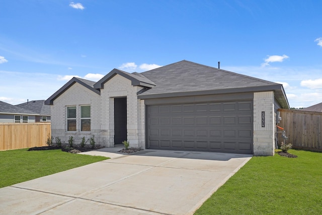 view of front of house featuring fence, an attached garage, a shingled roof, a front lawn, and brick siding