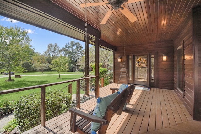 deck with a lawn and ceiling fan