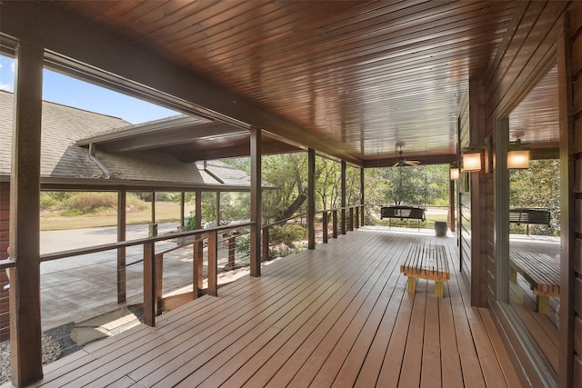 wooden terrace with ceiling fan and covered porch