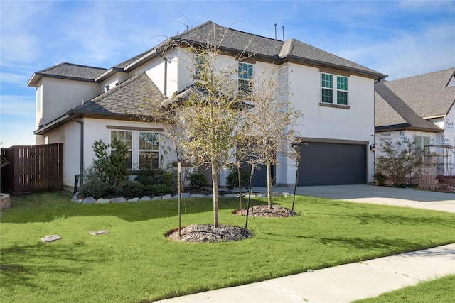 view of front of home with a front yard and a garage