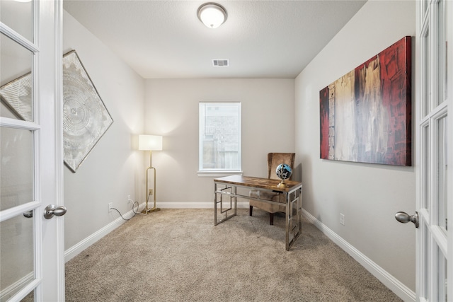 carpeted office featuring french doors