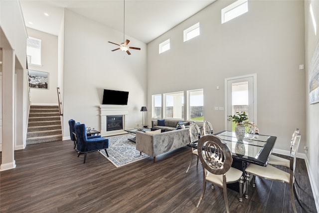 dining area with high vaulted ceiling, dark wood-type flooring, and ceiling fan