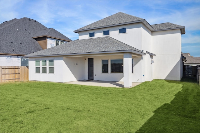 rear view of property with a patio area and a lawn