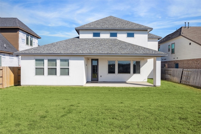 rear view of property with a patio and a yard