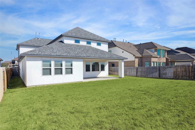 rear view of house featuring a yard and a patio area