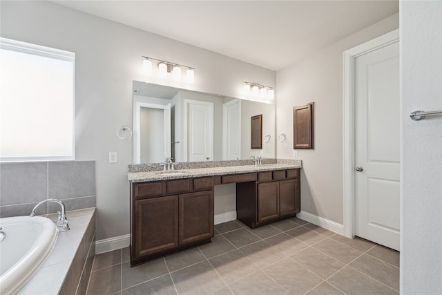 bathroom featuring vanity, tiled bath, and tile patterned flooring