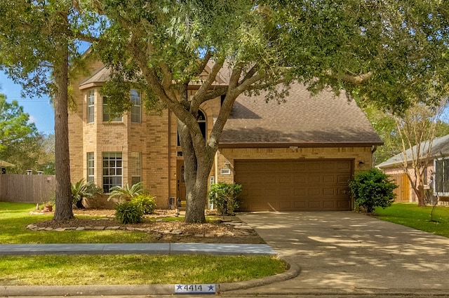 view of front of home featuring a front yard and a garage