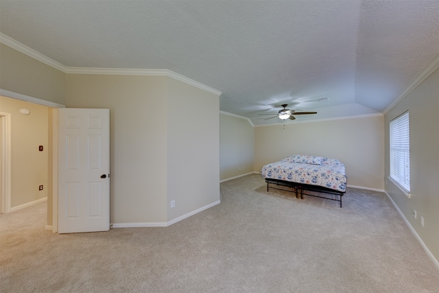 unfurnished bedroom featuring lofted ceiling, ornamental molding, and ceiling fan