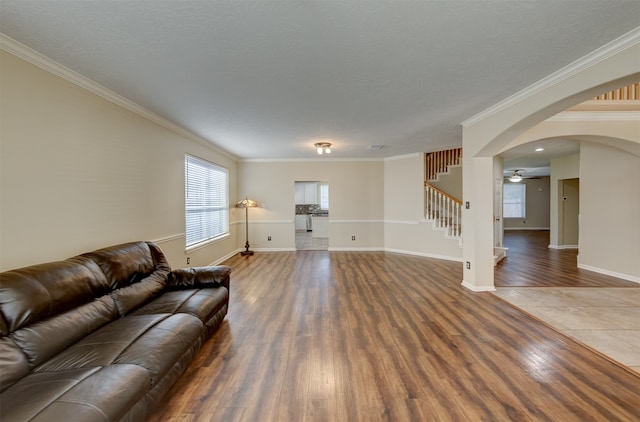 living room featuring crown molding, a textured ceiling, and dark hardwood / wood-style flooring