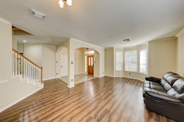 living room with crown molding, a textured ceiling, and dark hardwood / wood-style floors