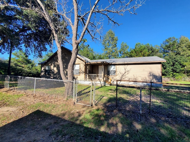 back of house with a lawn