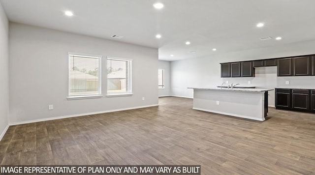 40746 Rosemary Rain, Magnolia, TX 77354 - kitchen with wood finished floors, a center island with sink, open floor plan, recessed lighting, and baseboards
