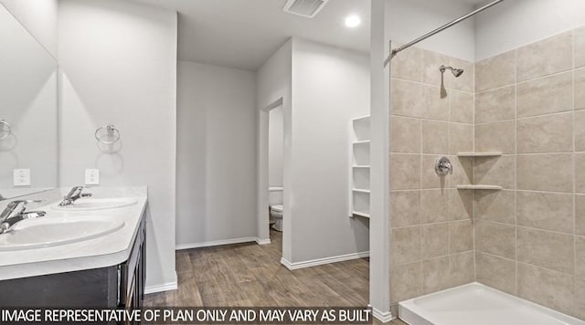 40746 Rosemary Rain, Magnolia, TX 77354 - full bathroom featuring wood finished floors, tiled shower, toilet, double vanity, and baseboards