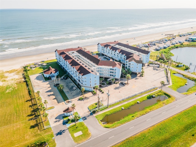 drone / aerial view with a water view and a view of the beach