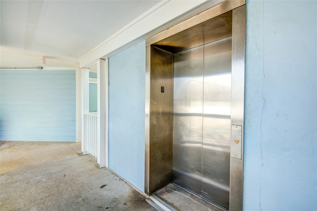 bathroom featuring concrete floors and elevator