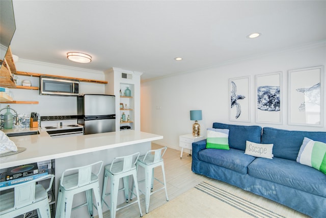 kitchen with sink, light wood-type flooring, kitchen peninsula, stainless steel appliances, and ornamental molding