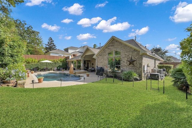 view of pool with a patio area, pool water feature, and a yard