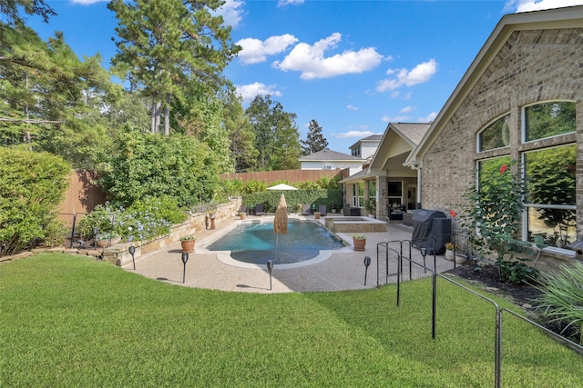 view of pool with a patio area, a lawn, and grilling area