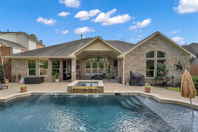 view of swimming pool featuring an in ground hot tub, pool water feature, area for grilling, and a patio area