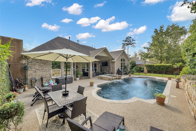 view of pool featuring a patio area, pool water feature, and an in ground hot tub