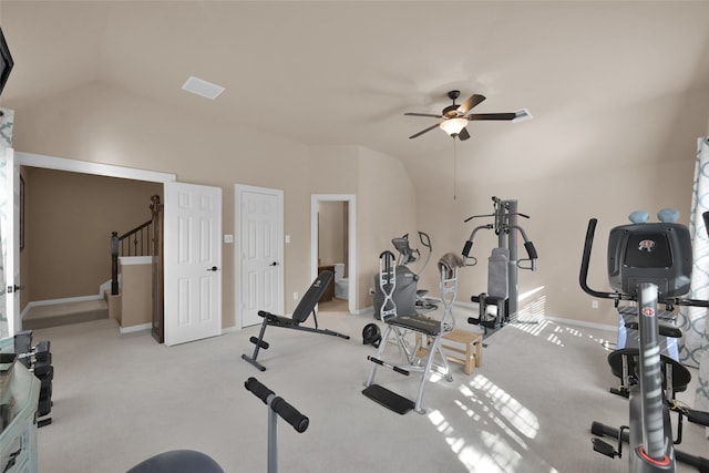 exercise room with ceiling fan, light carpet, and vaulted ceiling