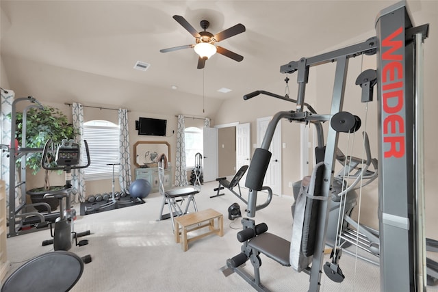 exercise room featuring light carpet, lofted ceiling, and ceiling fan