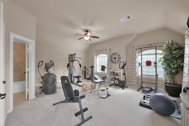 exercise area with ceiling fan, light carpet, and lofted ceiling