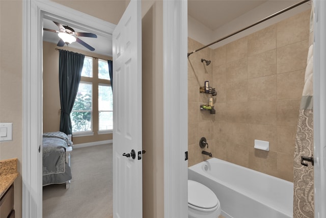 full bathroom featuring vanity, shower / bath combo, toilet, and ceiling fan