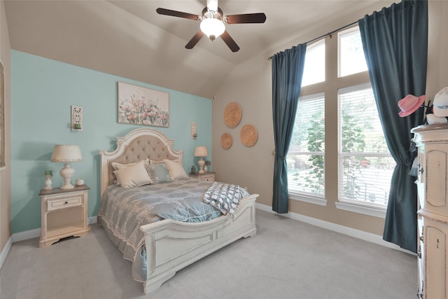 carpeted bedroom featuring ceiling fan, lofted ceiling, and multiple windows